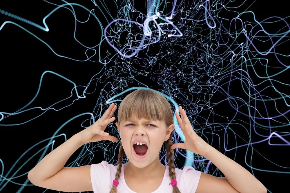 Child holding her hands beside her head against a background of tangled lines